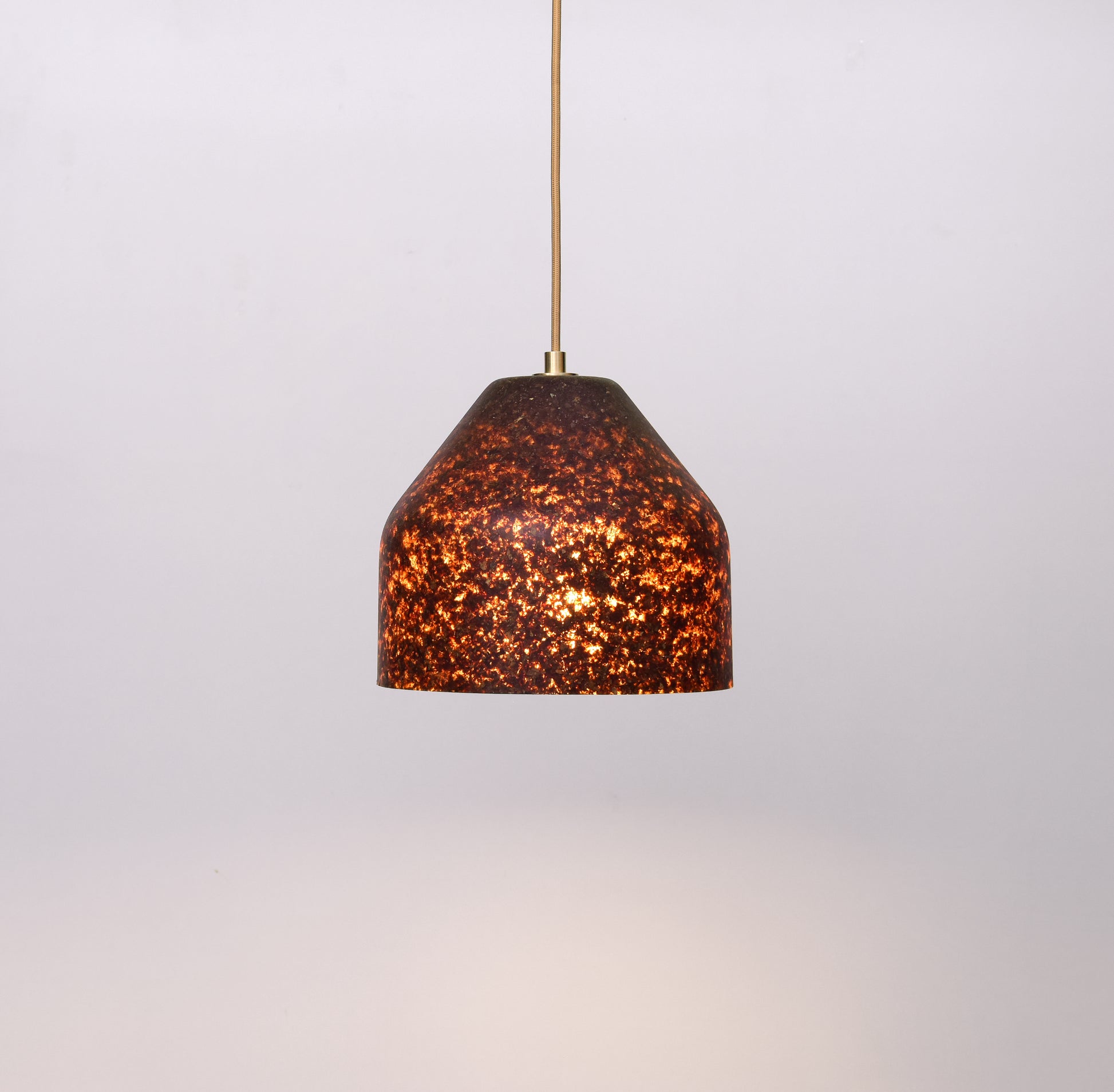 Pendant light with a brown, textured shade and bronze elements  on a white background