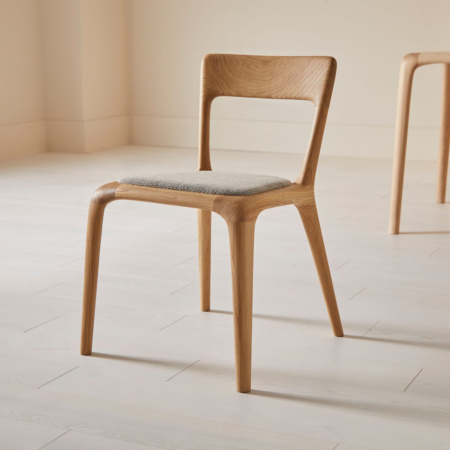 Flow dining chair in oak with an upholstered seat