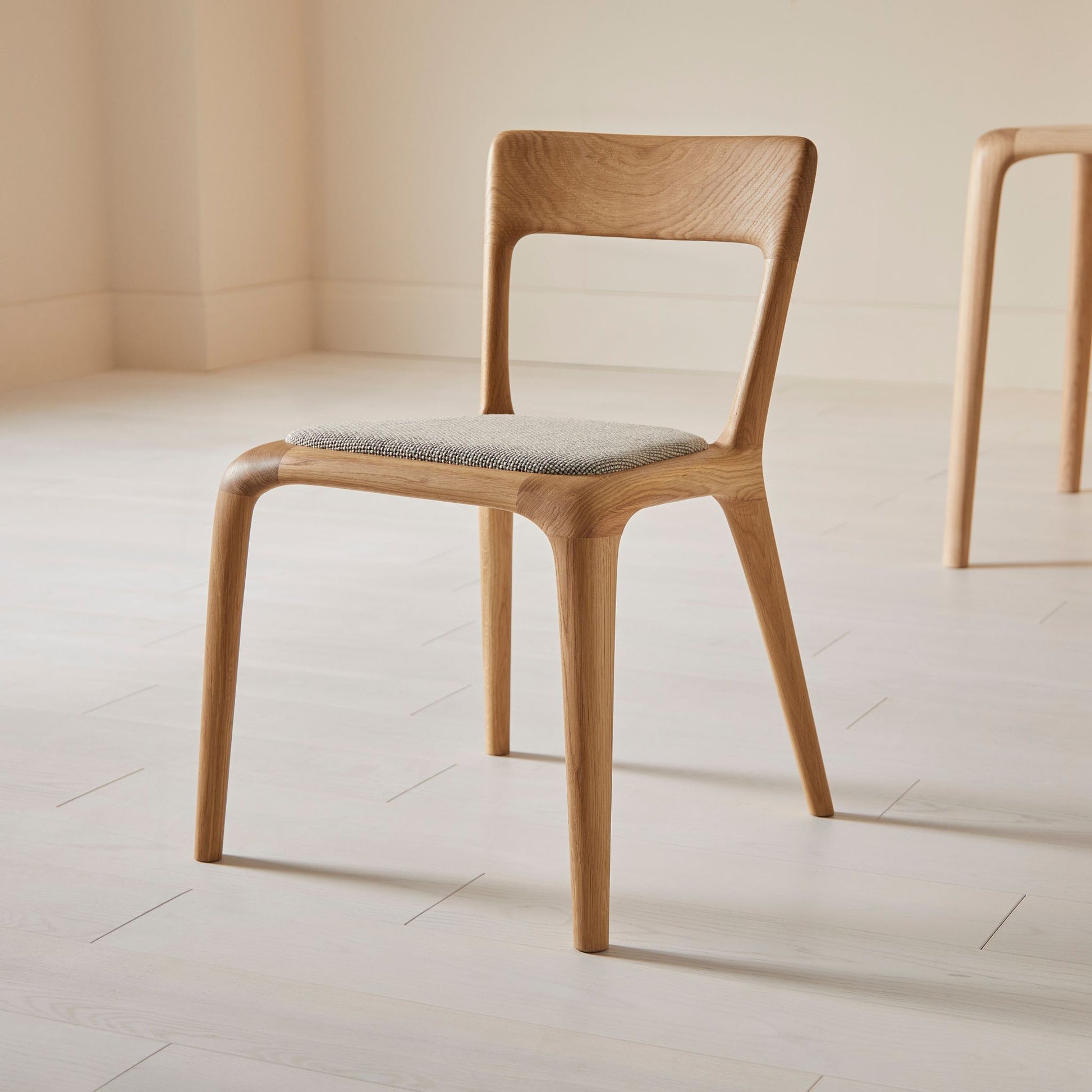 Flow dining chair in oak with an upholstered seat