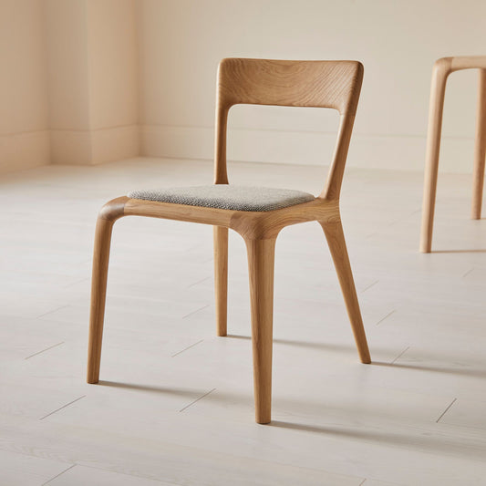 Flow dining chair in oak with an upholstered seat