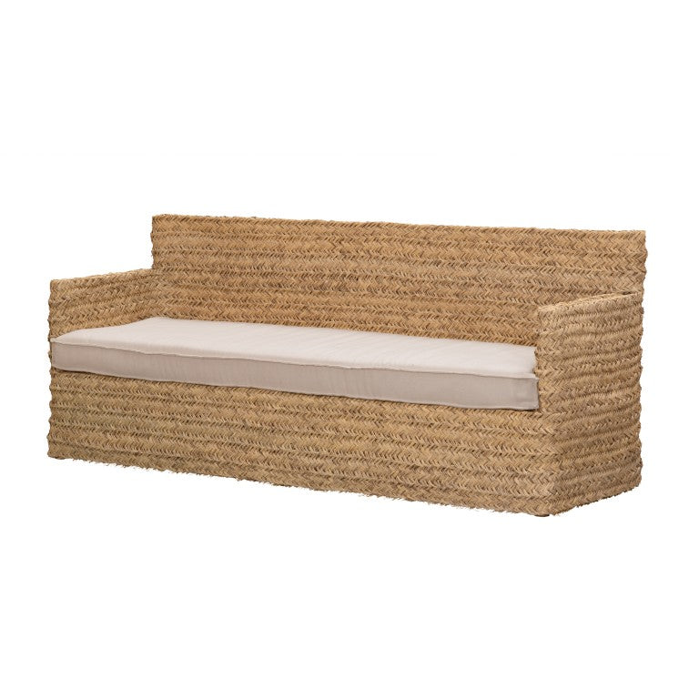 Woven sofa made with natural fibre esparto with a long white seating cushion on a white background .