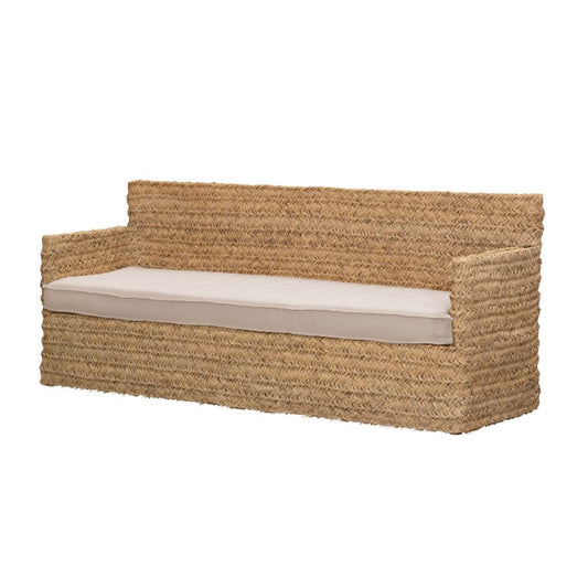 Woven sofa made with natural fibre esparto with a long white seating cushion on a white background .