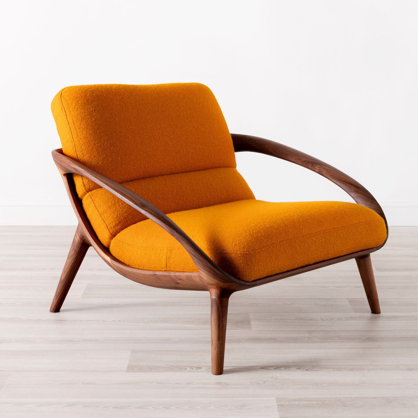 Moor lounge chair in walnut with orange wool upholstery